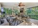 Relaxing outdoor porch with comfortable seating, an overhead fan, and a stone fireplace at 1500 Historic Vw, Stone Mountain, GA 30087