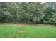 Lush backyard with mature trees, providing ample shade and a sense of privacy at 20 Friendship Rd, Euharlee, GA 30145