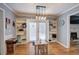 Bright dining area with french doors, built-in shelving, hardwood floors, and a stylish light fixture at 20 Friendship Rd, Euharlee, GA 30145