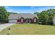 Charming brick home features a well-manicured lawn and colorful flower beds at 20 Friendship Rd, Euharlee, GA 30145