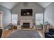 Bright living room features a fireplace, large windows, hardwood floors, and a ceiling fan at 20 Friendship Rd, Euharlee, GA 30145