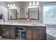 Main bathroom with a double vanity, two mirrors, and a large soaking tub at 20 Friendship Rd, Euharlee, GA 30145
