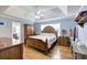 Main bedroom featuring tray ceiling, hardwood floors, and a bathroom through the doorway at 20 Friendship Rd, Euharlee, GA 30145