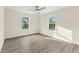 Bedroom featuring neutral walls, wood-look floors, and two large windows at 2331 Luther St, Lithonia, GA 30058