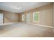 Spacious carpeted basement with white trim and two windows at 2774 Birch Grove Se Ln # 11, Marietta, GA 30067
