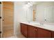 Bathroom features double sinks, warm wooden cabinets, and a separate area with a bathtub and shower, perfect for relaxation at 2774 Birch Grove Se Ln # 11, Marietta, GA 30067