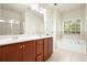 Bathroom features double vanity, soaking tub, and tiled shower with glass door, offering a serene and spa-like experience at 2774 Birch Grove Se Ln # 11, Marietta, GA 30067