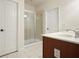 Well-lit bathroom with a tile shower, white countertop, and warm-toned wooden cabinetry with a tile floor at 2774 Birch Grove Se Ln # 11, Marietta, GA 30067