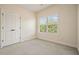 Bright bedroom features a window, carpet, and closet at 2774 Birch Grove Se Ln # 11, Marietta, GA 30067