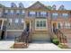 Charming brick townhome featuring an attached two-car garage and a welcoming front entrance with brick stairs at 2774 Birch Grove Se Ln # 11, Marietta, GA 30067