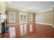 A bright living room with hardwood floors, a fireplace, and doors leading to an outdoor space at 2774 Birch Grove Se Ln # 11, Marietta, GA 30067