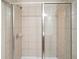 Modern tiled shower with sliding glass doors and a sleek shower head providing a spa-like experience at 2774 Birch Grove Se Ln # 11, Marietta, GA 30067