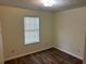 Neat bedroom with hardwood floors and natural light streaming through the window at 504 Edgewood Trce, Mcdonough, GA 30253