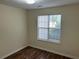 Simple bedroom with natural light, neutral walls, and laminate flooring at 504 Edgewood Trce, Mcdonough, GA 30253