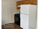 Efficient kitchen area with white refrigerator, gas stove and wood cabinets at 504 Edgewood Trce, Mcdonough, GA 30253