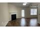 Bright living room featuring a fireplace, hardwood floors, and a glass door to the outside at 504 Edgewood Trce, Mcdonough, GA 30253
