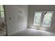 Bedroom featuring two windows and unfinished walls with a toilet in background at 854 Mcdonough Se Blvd, Atlanta, GA 30315