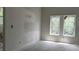 Bedroom featuring two windows and unfinished walls with a toilet in background at 854 Mcdonough Se Blvd, Atlanta, GA 30315