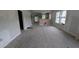 Large living room with bare concrete floors and kitchen in the background at 854 Mcdonough Se Blvd, Atlanta, GA 30315