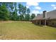 Expansive backyard featuring lush green grass and mature trees, perfect for outdoor activities at 902 Edgewater Dr, Loganville, GA 30052