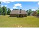Brick home featuring a large, well-maintained backyard with a covered patio, ideal for entertaining at 902 Edgewater Dr, Loganville, GA 30052