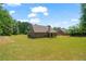 Beautiful brick home with a spacious backyard and covered patio area, perfect for relaxing outdoors at 902 Edgewater Dr, Loganville, GA 30052
