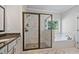 Bathroom features walk-in shower, soaking tub, and granite counters at 902 Edgewater Dr, Loganville, GA 30052