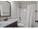 Full bathroom featuring granite countertops, tub with shower, and modern fixtures at 902 Edgewater Dr, Loganville, GA 30052