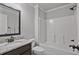 Bathroom features granite counters, large mirror, and shower-tub combo at 902 Edgewater Dr, Loganville, GA 30052