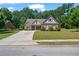 Charming single-Gathering home with brick facade, manicured lawn, and a paved driveway leading to a cozy entrance at 902 Edgewater Dr, Loganville, GA 30052