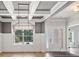 Elegant room featuring coffered ceilings, modern light fixture, and a view of the front yard, creating a grand entrance at 902 Edgewater Dr, Loganville, GA 30052