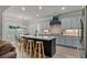 Modern kitchen with a large center island, granite countertops, and stainless steel appliances at 902 Edgewater Dr, Loganville, GA 30052