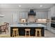 Stylish kitchen featuring an island with seating, granite countertops, and modern appliances at 902 Edgewater Dr, Loganville, GA 30052