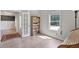 Bright living room featuring wood floors, a bookcase, and a large window providing natural light at 902 Edgewater Dr, Loganville, GA 30052