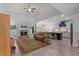 Open-concept living area with a stone fireplace, wood floors, and seamless flow to the modern kitchen at 902 Edgewater Dr, Loganville, GA 30052