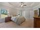 Stylish main bedroom with carpet, ceiling fan, and a view through a window at 902 Edgewater Dr, Loganville, GA 30052
