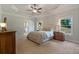 Spacious main bedroom featuring a ceiling fan, windows offering view, and neutral carpet flooring at 902 Edgewater Dr, Loganville, GA 30052