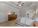 Serene main bedroom featuring a ceiling fan, dresser, and ample natural light at 902 Edgewater Dr, Loganville, GA 30052