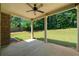 Covered patio with brick siding, lush landscaping, and outdoor living space at 902 Edgewater Dr, Loganville, GA 30052