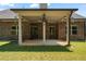 Covered patio featuring ceiling fan and view of the green backyard at 902 Edgewater Dr, Loganville, GA 30052