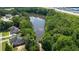 Scenic aerial view of a serene pond surrounded by lush greenery, near residential homes at 902 Edgewater Dr, Loganville, GA 30052
