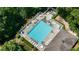 Aerial view of a refreshing community pool with ample lounging space surrounded by manicured landscaping at 902 Edgewater Dr, Loganville, GA 30052