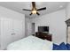 Bright bedroom with white walls, carpet, ceiling fan, walk-in closet, and bedroom furniture at 109 Paulownia Cir, Mcdonough, GA 30253