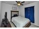 Bedroom featuring plush carpet, ceiling fan, dark curtains, and a modern dresser and bed at 109 Paulownia Cir, Mcdonough, GA 30253