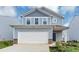 Traditional two-story home boasts an attached two-car garage, complemented by fresh landscaping and concrete driveway at 109 Paulownia Cir, Mcdonough, GA 30253