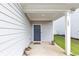 Front porch featuring a dark blue front door, house number, and outdoor plants at 109 Paulownia Cir, Mcdonough, GA 30253