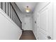 Hallway view features a staircase, a front door, and a light fixture at 109 Paulownia Cir, Mcdonough, GA 30253