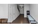 Hallway featuring dark wood floors, white doors, and a staircase at 109 Paulownia Cir, Mcdonough, GA 30253