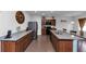 Kitchen showcasing stone countertops, wooden cabinetry, stainless steel appliances, and a large island at 109 Paulownia Cir, Mcdonough, GA 30253