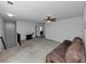 Spacious living room with a ceiling fan, stairs, space for a desk and an oversized leather couch at 109 Paulownia Cir, Mcdonough, GA 30253